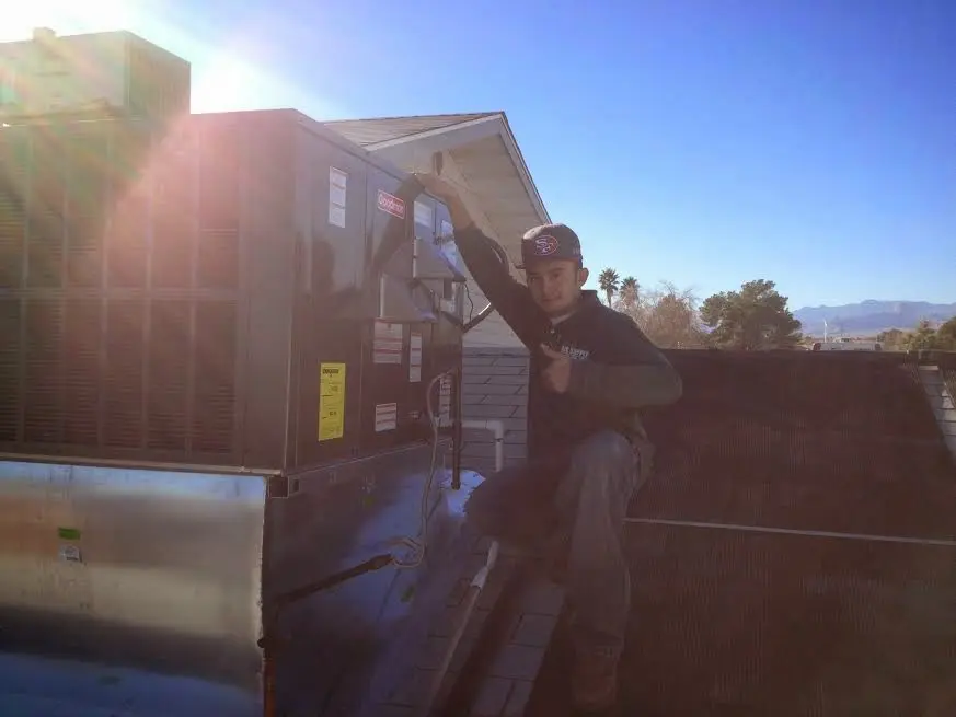HVAC technician performing Boiler Repair on a rooftop unit in Portland